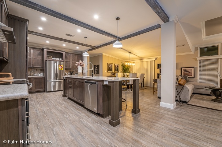 Open Concept Kitchen Living Area with Dark Cabinetry and Wood Beams