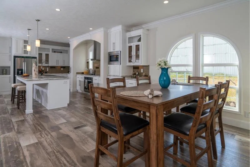 Open Concept Kitchen with Arched Windows and White Shaker Cabinetry