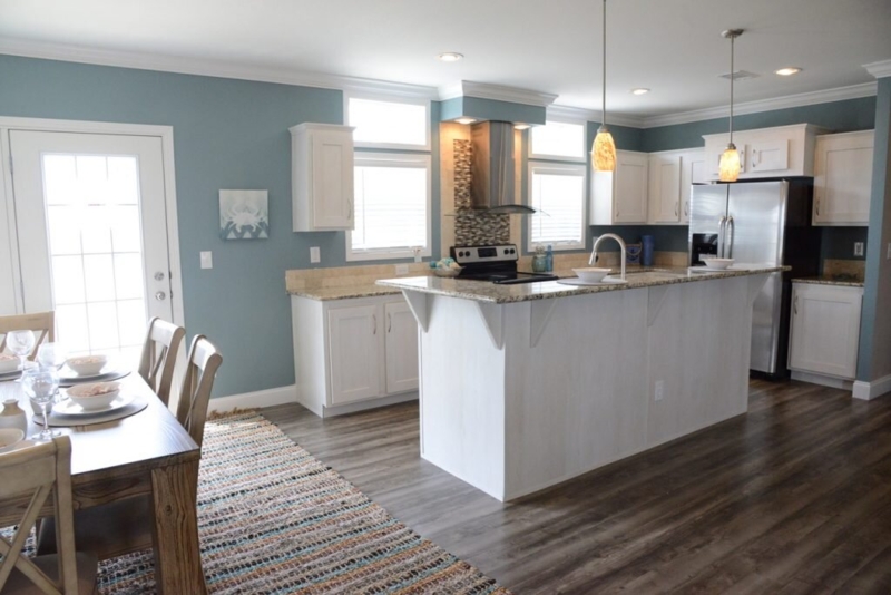 Open Concept Kitchen with Coastal Blue Walls and White Shaker Cabinets