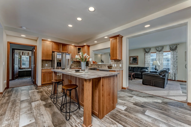 Open Concept Kitchen with Warm Wood Cabinetry and Wide Plank Flooring