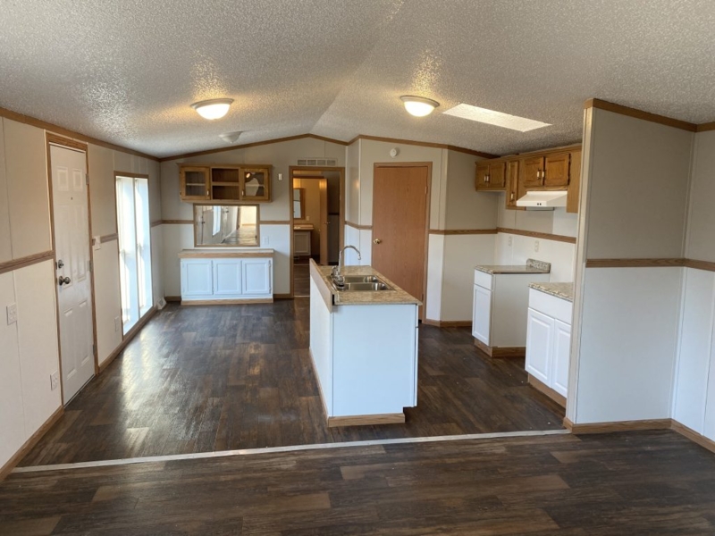 Open Concept Mobile Home Kitchen with Vaulted Ceiling and Skylight