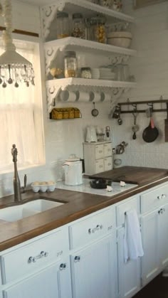 Ornate Open Shelf Brackets in a White Farmhouse Kitchen