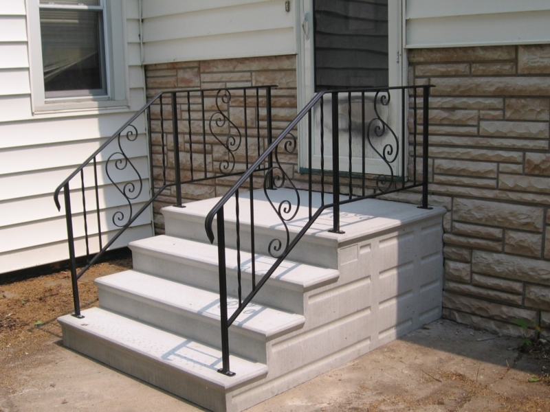 Outdoor Steps, Ornate Black Railings with Scrollwork, Precast Entry.
