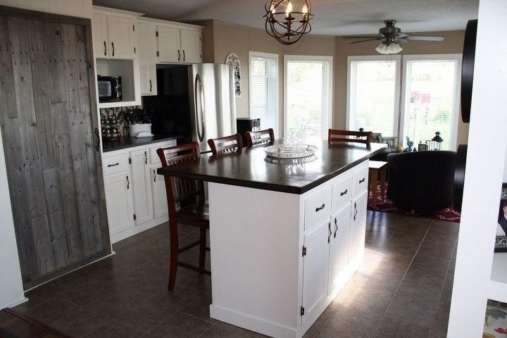 Oversized White Island Kitchen Design with Rustic Barn Door Pantry