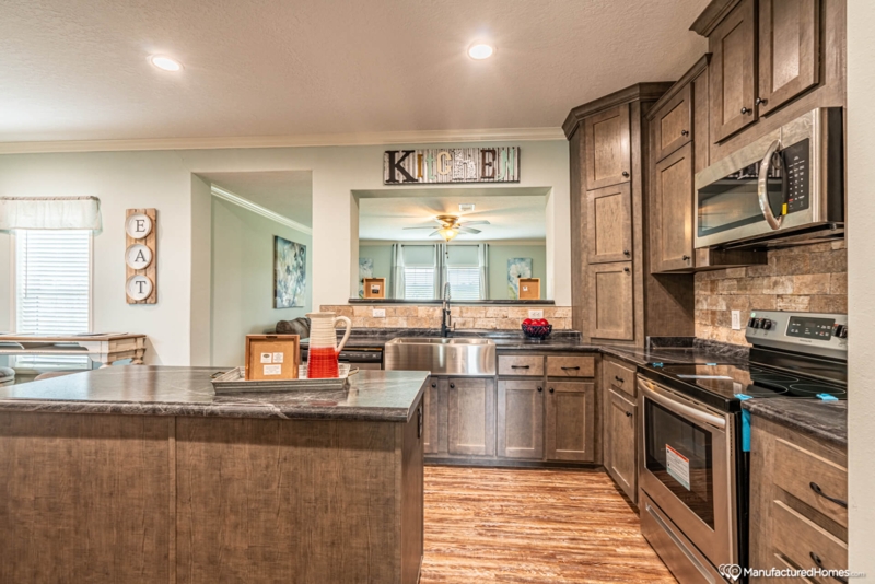 Pass-Through Window Kitchen Design with Marbled Island Counter.