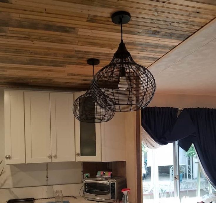 Pendant Light: Black Wire Mesh Shade under Rustic Wood Plank Ceiling