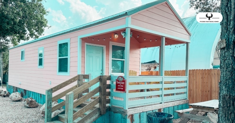 Pink Mobile Home Exterior with Light Blue Trim and Porch