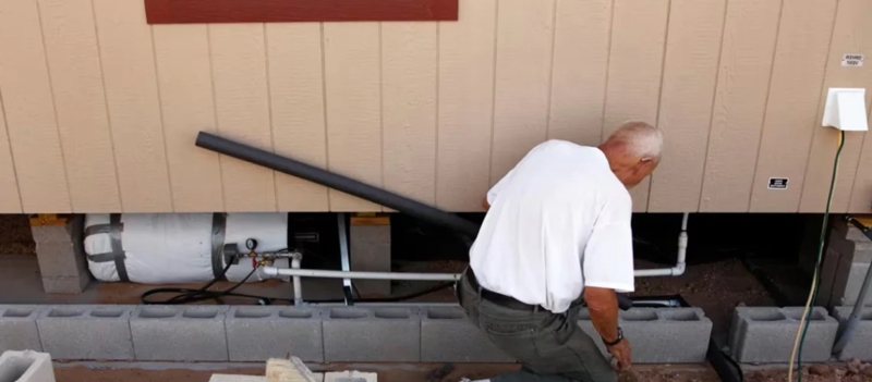 Plumbing System: Insulated Utility Setup with Water Tank in Crawl Space