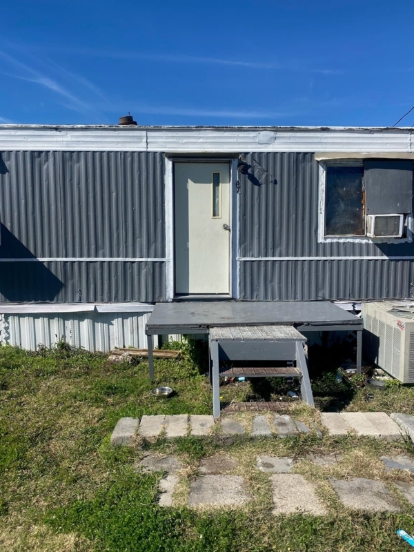 Porch Platform with Corrugated Metal Siding and Outdoor Steps