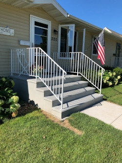 Precast Concrete Steps, White Metal Railing with Four-Tier Design.