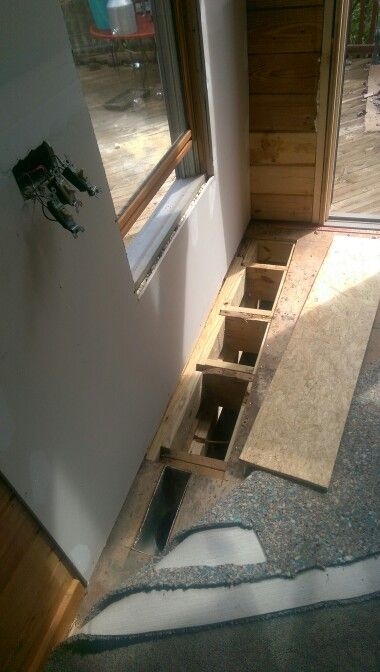 Preparing Subfloor for Renovation: Cut-Out Section Reveals Joists