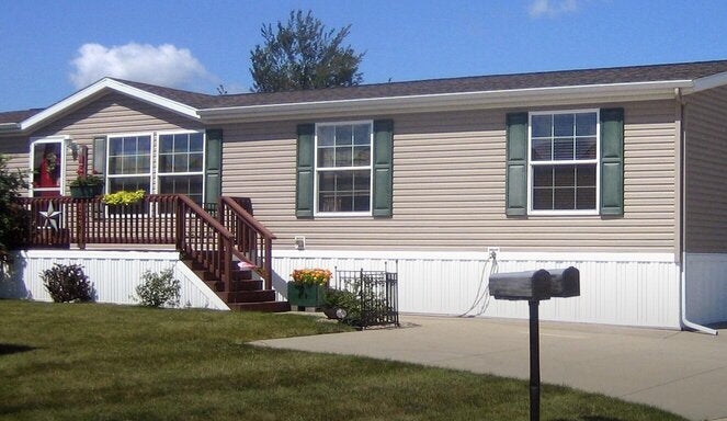 Residential Exterior Tan Siding with Green Shutters and White Skirting