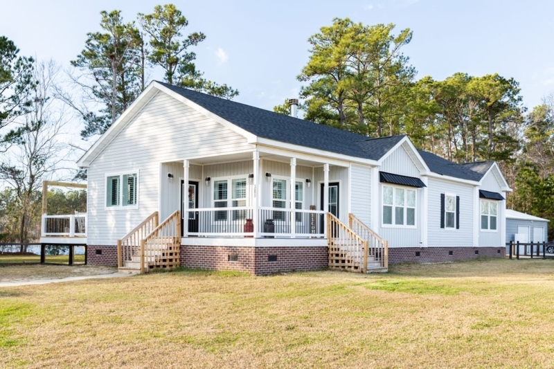 Residential Exterior White Siding Brick Foundation Metal Awnings