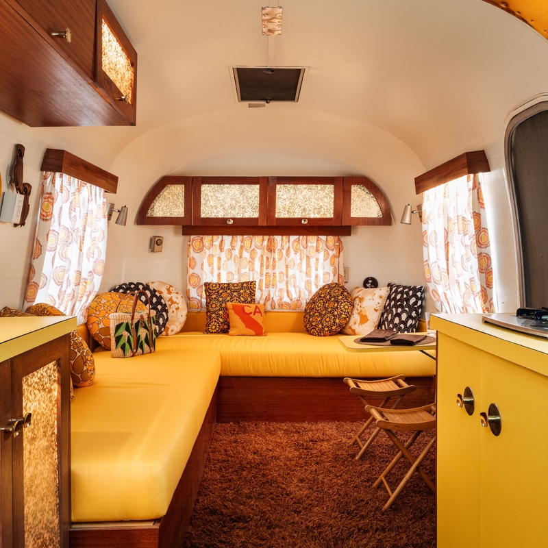 Retro Trailer Lounge with Yellow Built-In Seating and Shag Carpet