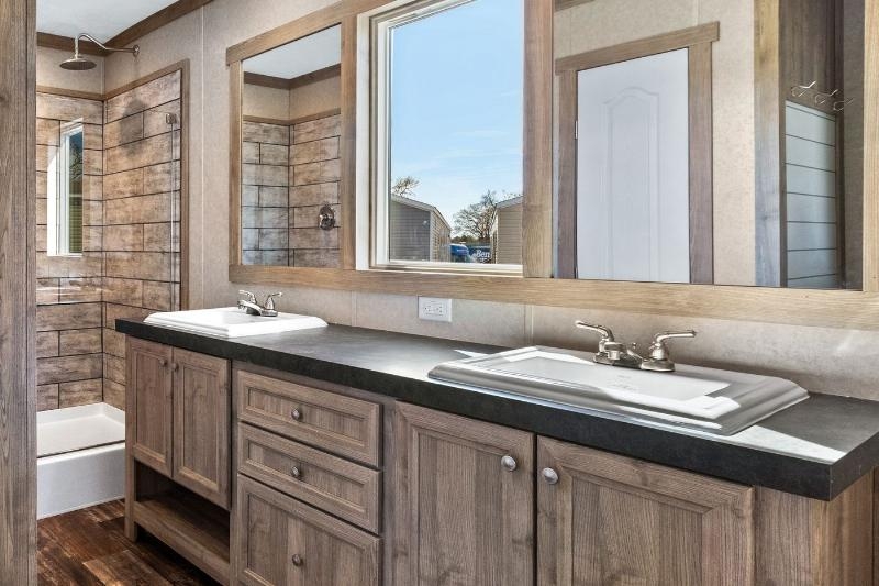 Rustic Double Vanity with Dark Countertop and Wood Look Shower Tile