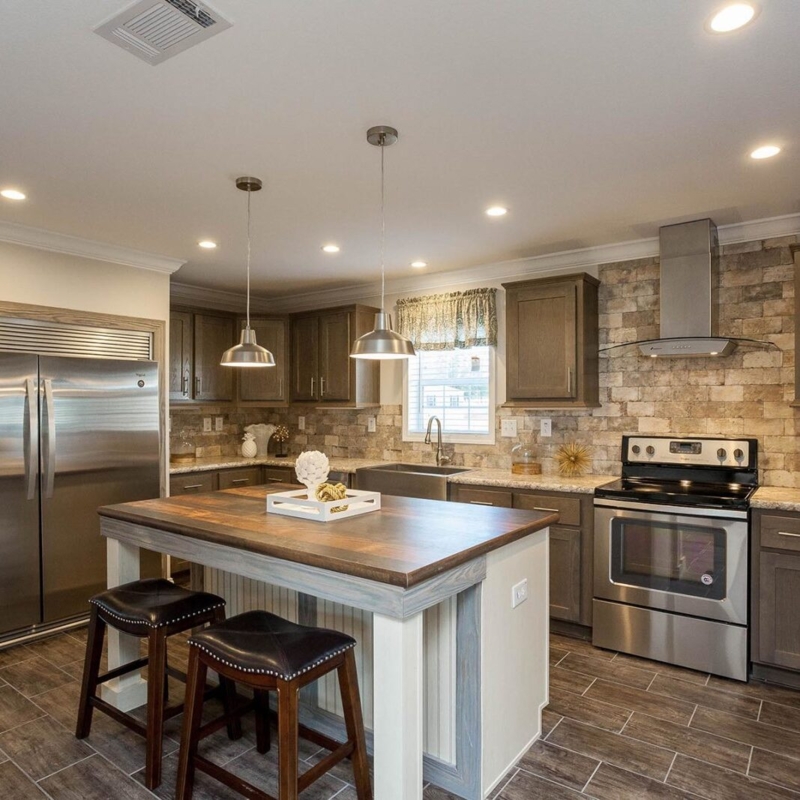 Rustic Kitchen Featuring Wood Topped Island and Stone Backsplash