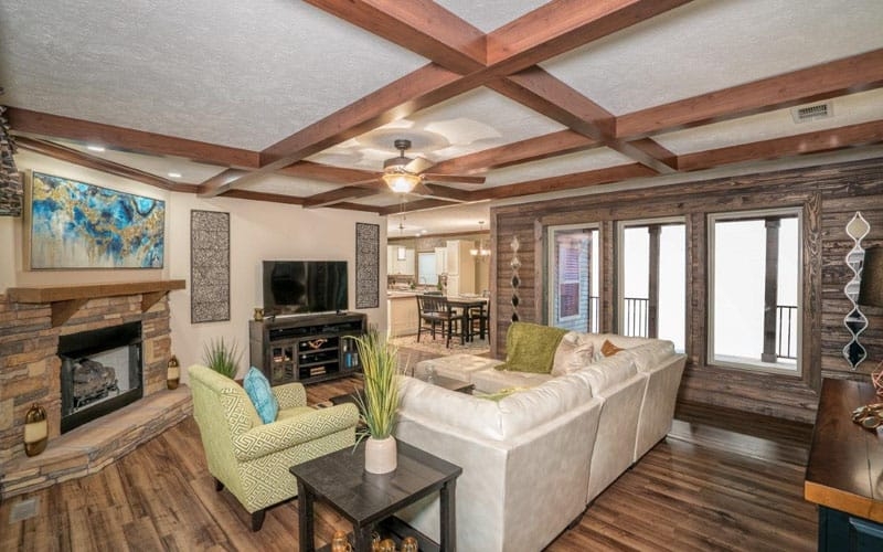 Rustic Living Room with Beamed Ceiling and Stone Fireplace Surround
