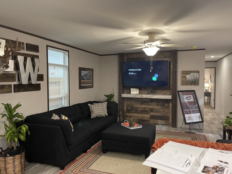 Rustic Living Room with Wood-Paneled TV Accent Wall and Black Sectional