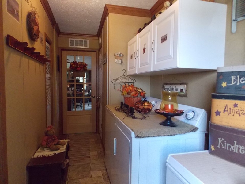 Rustic Manufactured Home Laundry Hallway with Beige Board and Batten Walls