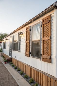Rustic Wood Lattice Shutters on White Siding Mobile Home Exterior