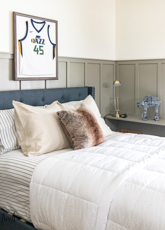 Sage Green Board and Batten Bedroom with Framed Sports Jersey Art