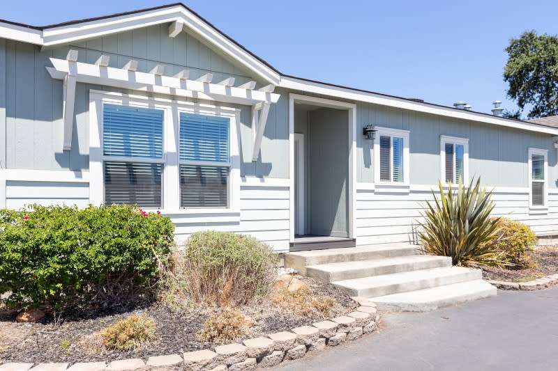 Sage Green House Exterior with White Window Pergola Design and Steps