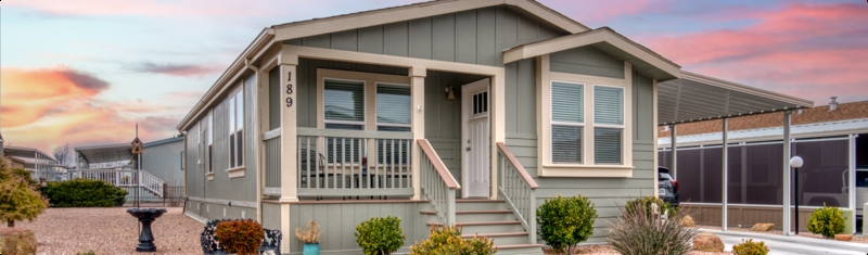 Sage Green Manufactured Home Exterior with Integrated Carport and Porch