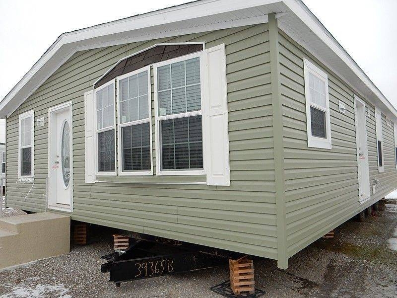 Sage Green Manufactured Home Exterior with White Shutters