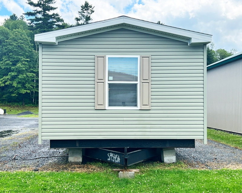 Sage Green Mobile Home Exterior with Tan Shutters and White Trim