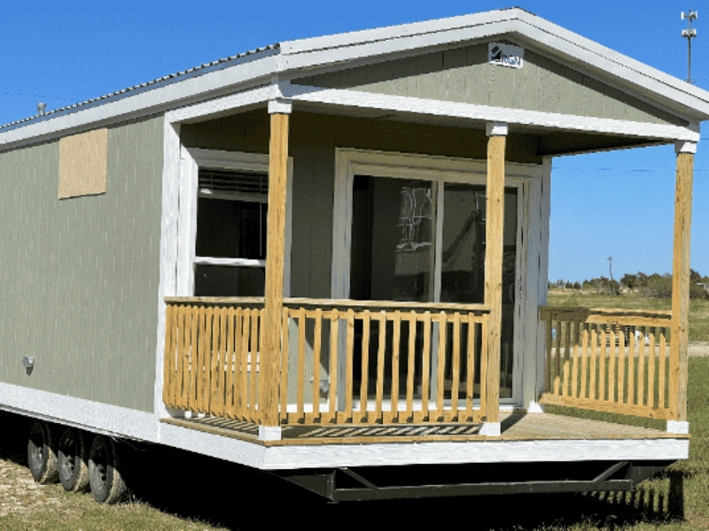 Sage Green Tiny Home with Built-In Front Porch and Wood Railing