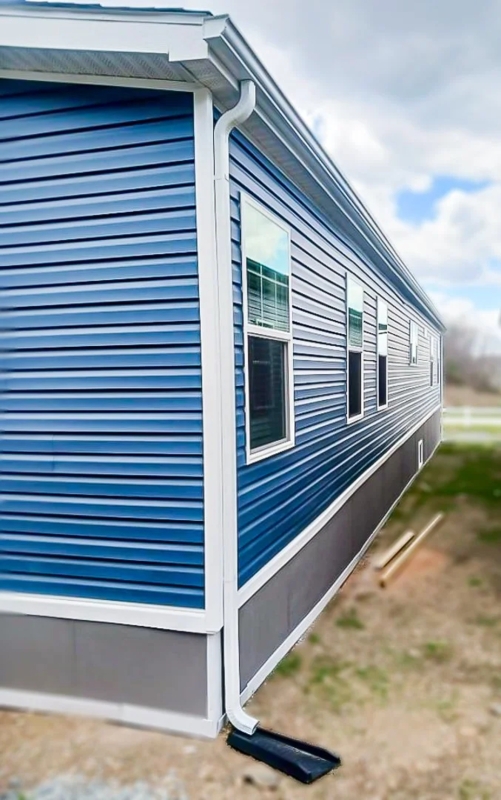 Seamless Gutter System Installation on Blue Lap Siding Exterior