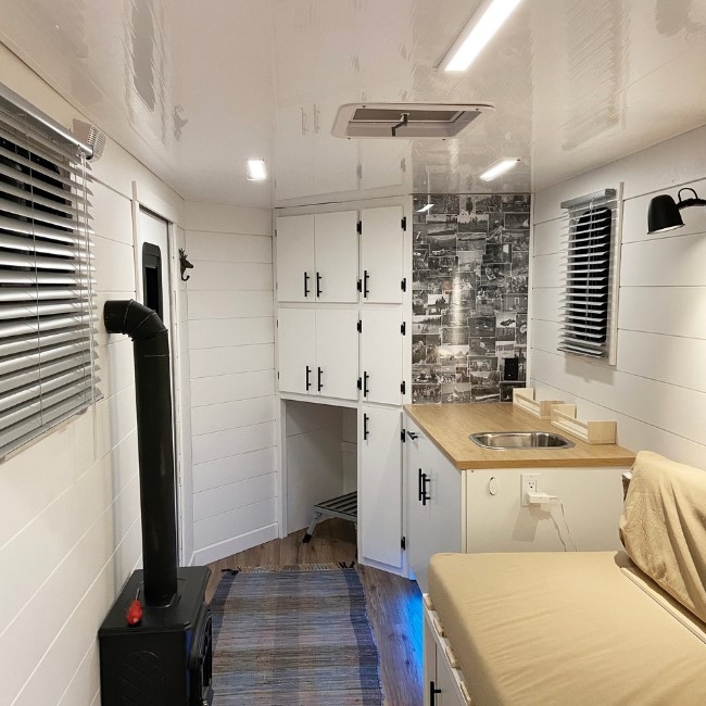 Shiplap Walls: Cozy Mobile Home Interior with Wood Burning Stove