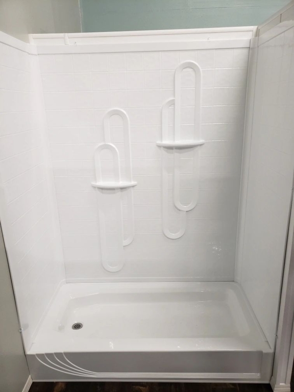 Shower Stall with Unique Arched Recesses and Low Threshold Base.