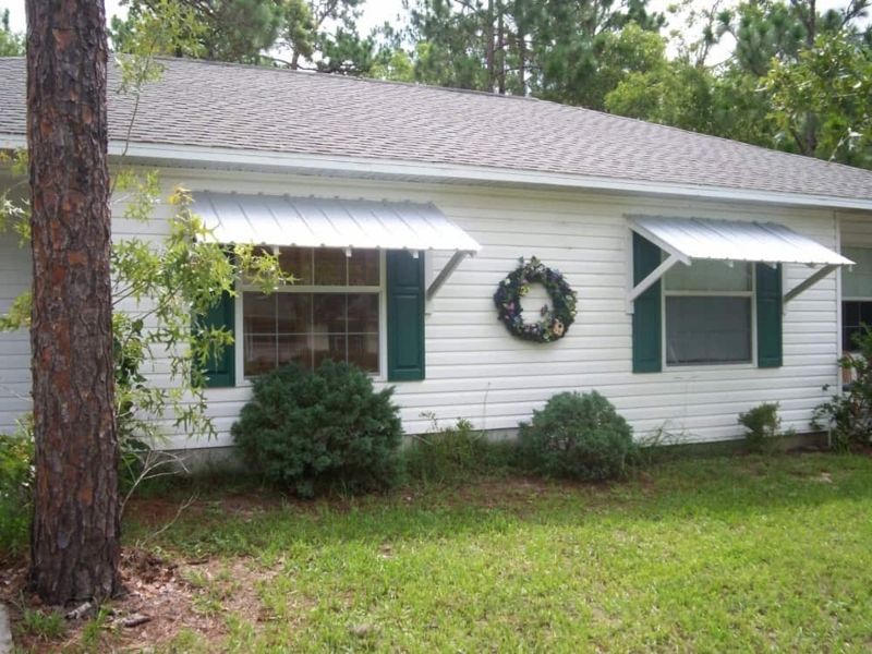 Silver Corrugated Metal Slanted Window Awnings
