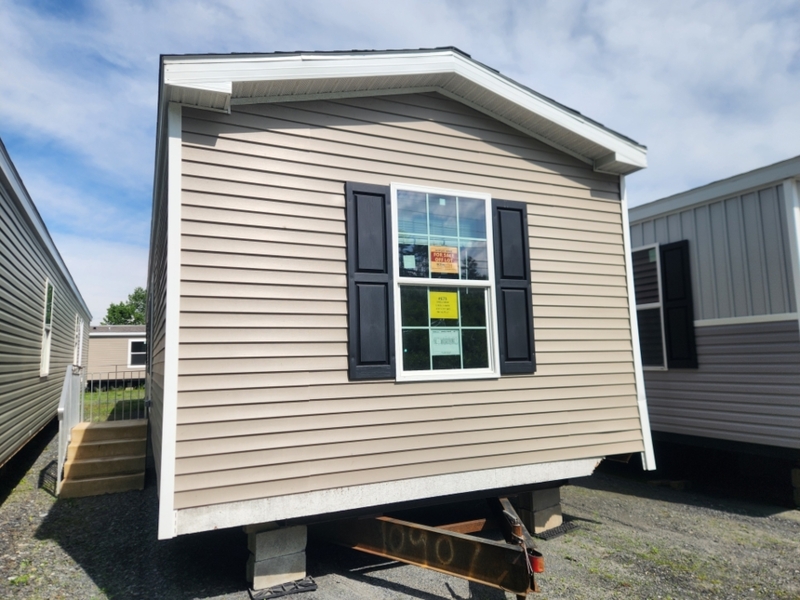 Single-Section Mobile Home with Tan Siding and Black Shutters