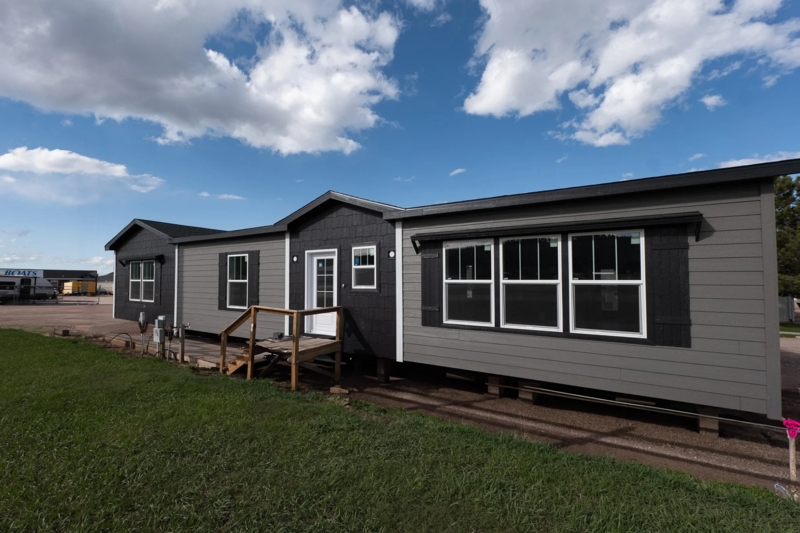 Slate Gray Manufactured Home with Black Shutters and Gabled Entryway
