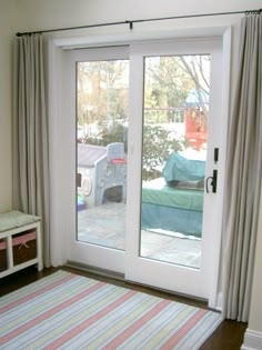Sliding Patio Door with Wide Trim and Coastal Drapery Styling