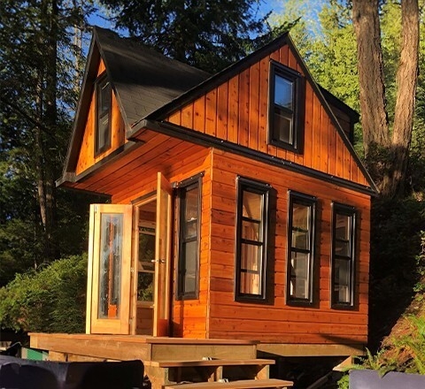 Small Cabin with Two Story Design and Black Trimmed Windows