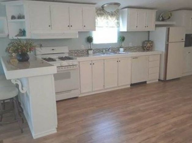 Small Kitchen Breakfast Bar Layout: White Cabinets and Wood Floors