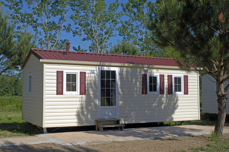 Small Manufactured Home with Burgundy Metal Roof and Shutters