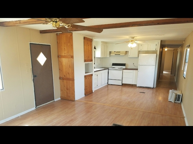 Small Open Concept Kitchen: Exposed Beams and Light Wood Flooring