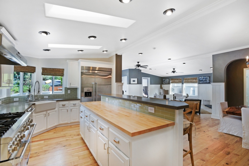 Spacious Kitchen with Dual Skylights and Butcher Block Island Design.