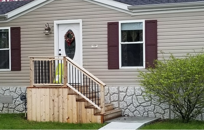 Stone Look Skirting with Burgundy Shutters and Oval Lite Door