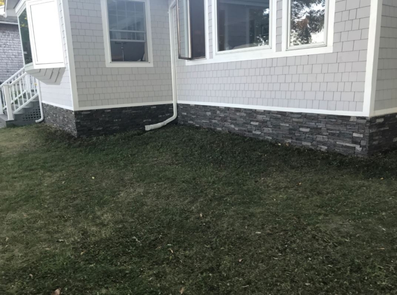 Stone Veneer Skirting: Dark Charcoal Stacked Panels below Gray Shake Siding