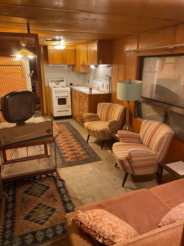 Striped Club Chairs and Retro TV in Vintage Wood Paneled Trailer