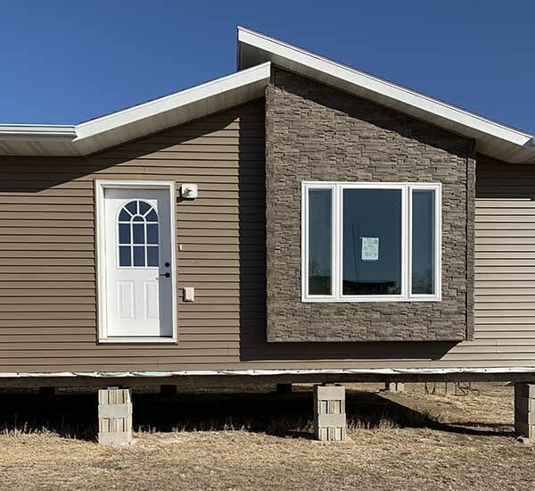 Tan Lap Siding with a Faux Stacked Stone Accent Section
