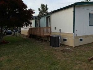Tan Masonry-Look Skirting Panels with Raised Wooden Deck