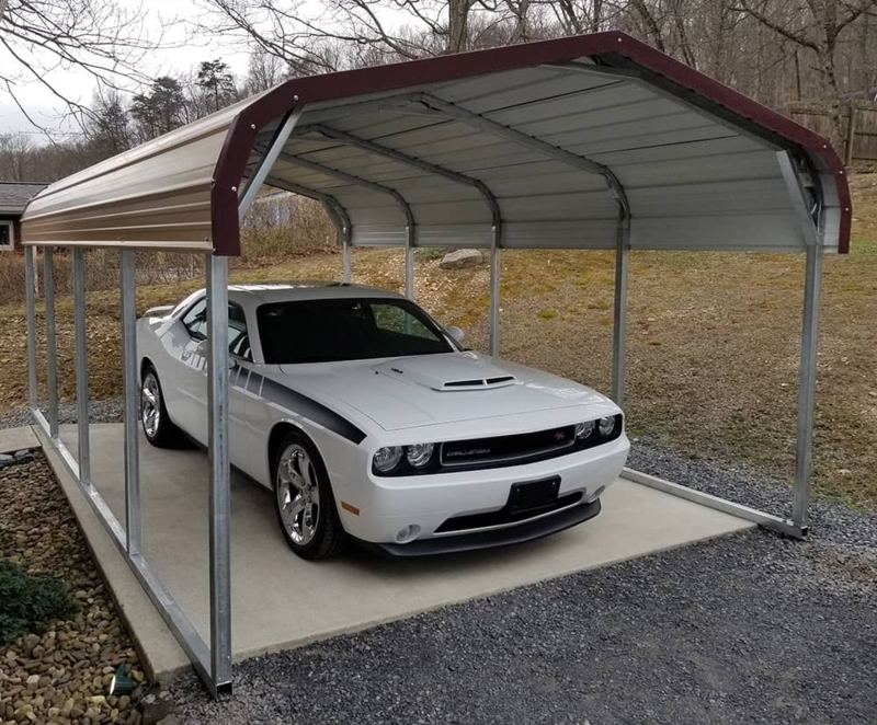 Tan Metal Carport for Driveway with Maroon Trim and Peaked Roof