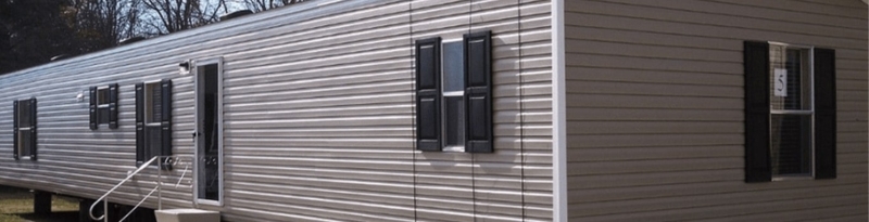 Tan Mobile Home Exterior with Black Shutters and Vinyl Siding