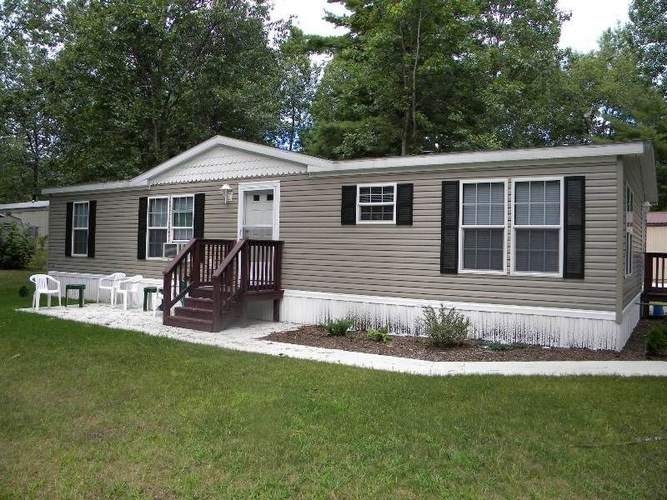 Tan Siding Mobile Home Exterior with Black Shutters